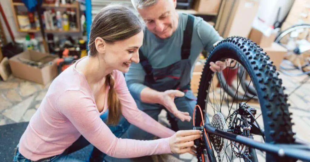 an image of a man and a woman doing maintanence on an electric bike together