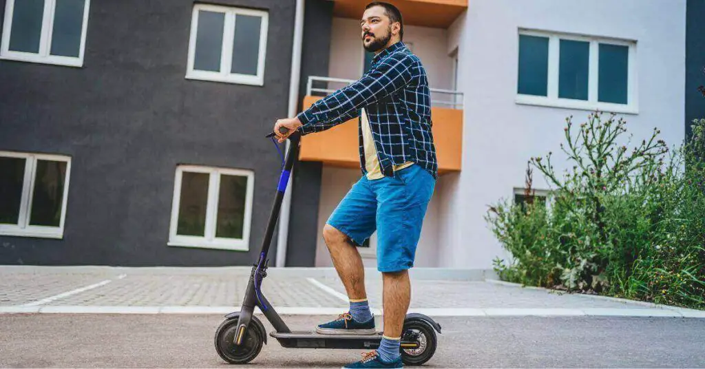 an image of a man riding his electric scooter
